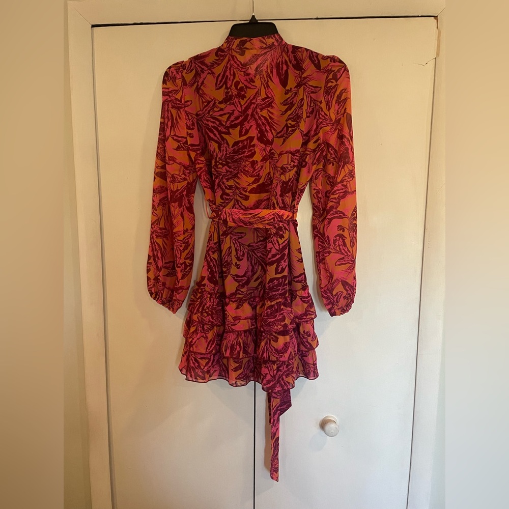 Pink and tan ruffle bottom mini dress with sleeves and belt size large like new.